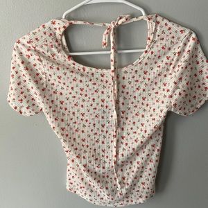 White, red, and pink flower shirt.